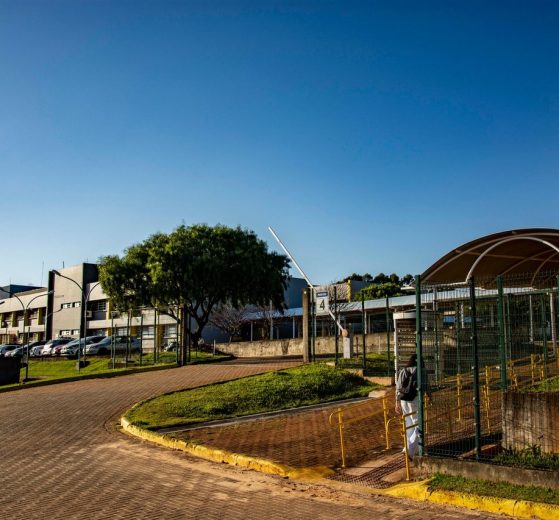 Vista de um campus universitário em Apucarana, no Paraná, com edifícios e áreas arborizadas sob céu azul.